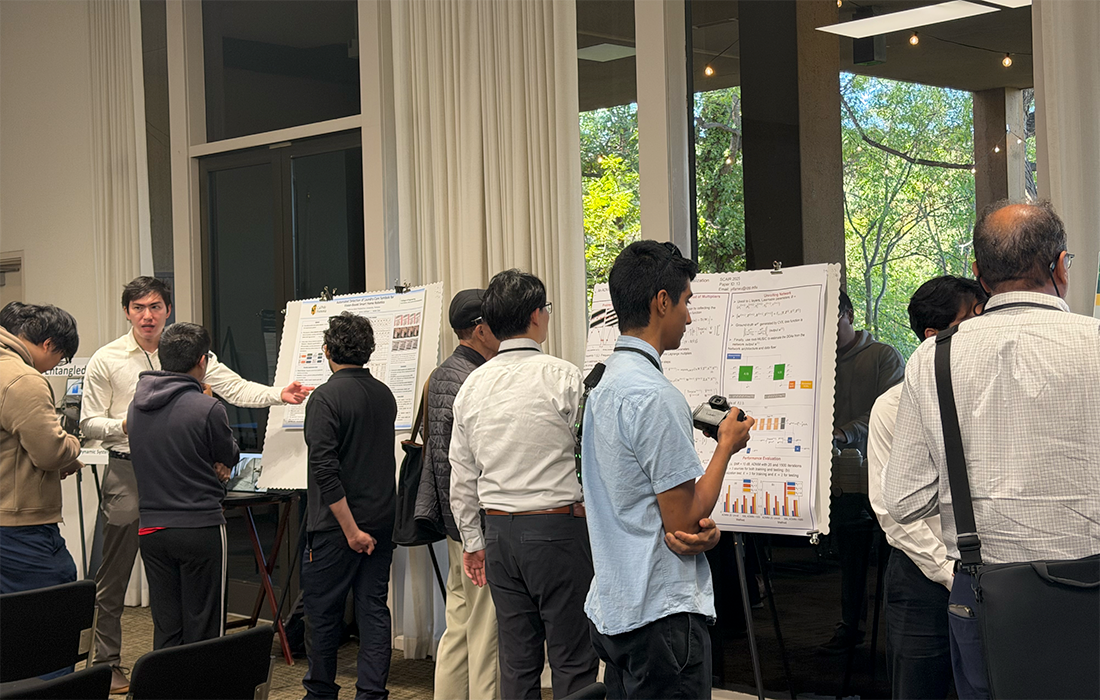 Male attendees look at a poster session