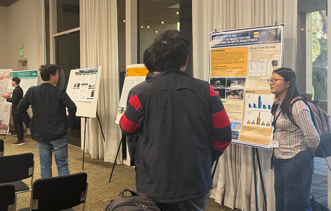A female attendee stops at a poster session during SCAIR 2025.