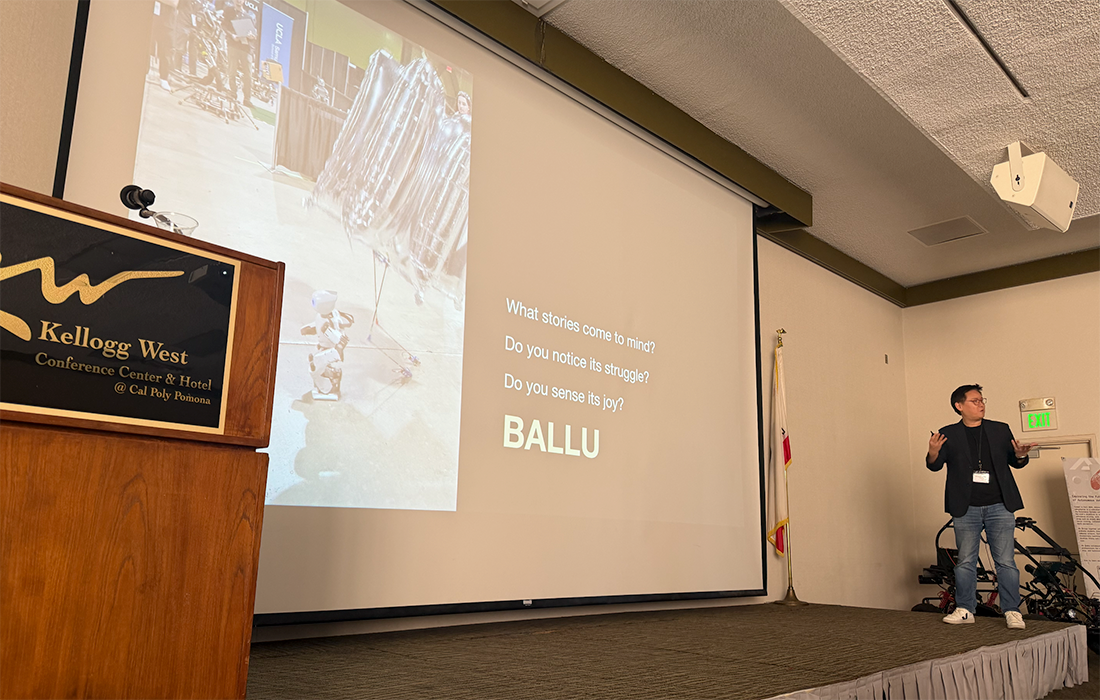 A male presenter speaks on stage at Kellogg West during SCAIR 2025.