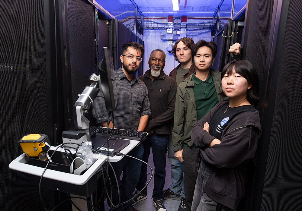  AI Sandbox students pose by the Supermicro Graphics Processing Unit.