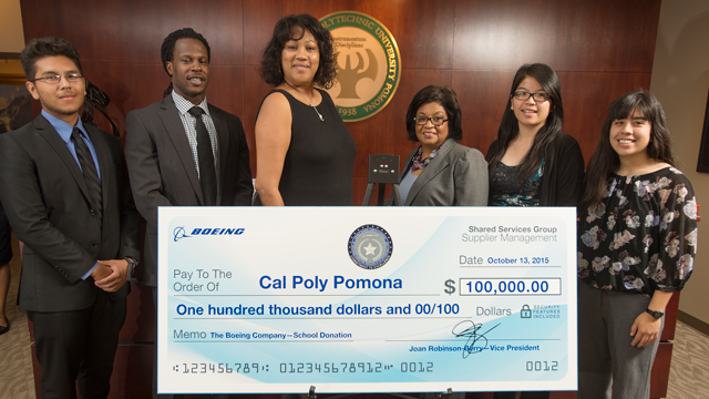Vice President Joan Robinson-Berry presents a $100,000 check to University President Soraya M. Coley.