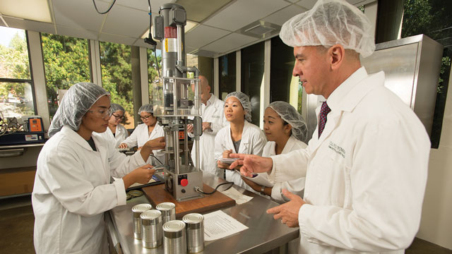 Professor Martin Sancho-Madriz, chair of the Department of Human Nutrition &amp; Food Sciences, with students in the renovated Food Technology Lab.