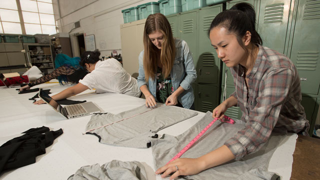 Jenny Vu and Lindsey Klein work on a t shirt during AMM production class.