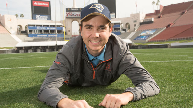 Plant Science student Sean McLaughlin on the playing field at the Los Angeles Coliseum in preparation for the Rams game against the Atlanta Falcons. McLaughlin has worked at the Coliseum for the past two years and will intern at the Super Bowl in Houston.