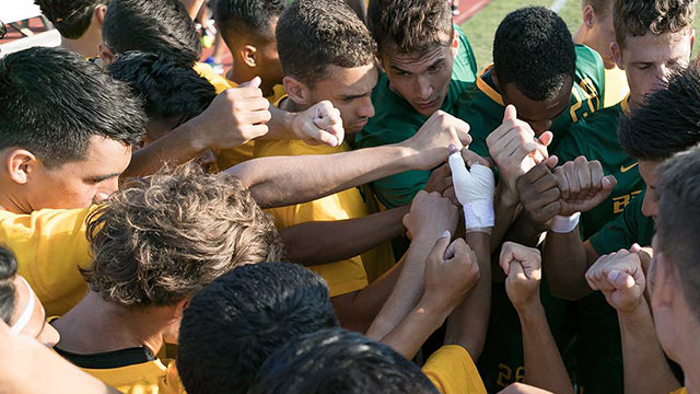 The men's soccer team celebrate a win during their season.