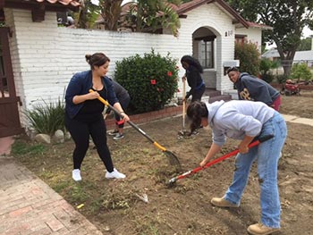 Cal Poly Pomona students do yard work at Urban Mission in Pomona.