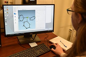 2)Chemistry Professor Chantal Stieber looks at sample results from Cal Poly Pomona's new Single Crystal X-Ray Defractometer, a top of the line machine purchased with a Department of Defense grant.