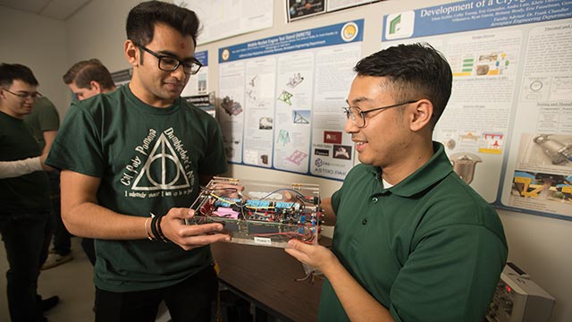 Engineering students Alden Caterio and Deep Patel work on a project they hope will best the world record for the longest flight by an electric powered unmanned aerial vehicle.