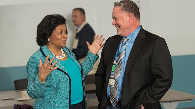 University President Soraya M. Coley chats with Rod Zerbel, director of personnel services for the Covina Valley Unified School District, during a summit with school districts administrators and principals.