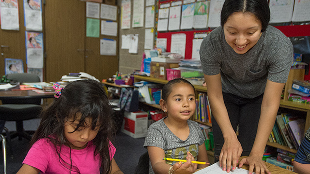 Melody Banuelos, a Prete Fellow, works with youngsters at Armstrong Elementary School.