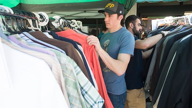 A student goes through a rack of clothing at the Career Center's Clothes Closet.