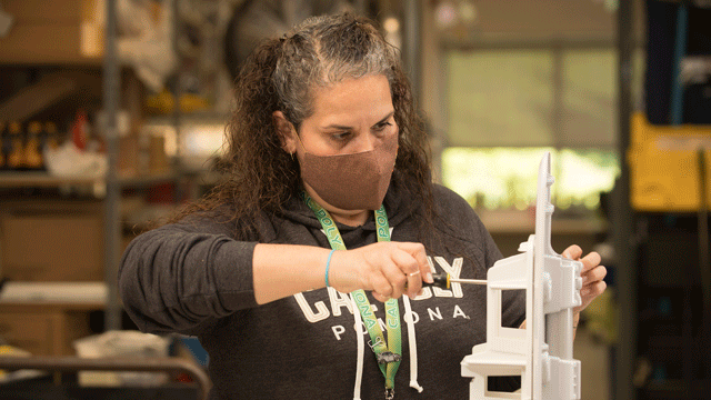 Victoria Tapia, who handles the library's shipping and receiving, puts together a hand sanitizer.