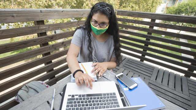 Neelam Mistry working on her laptop