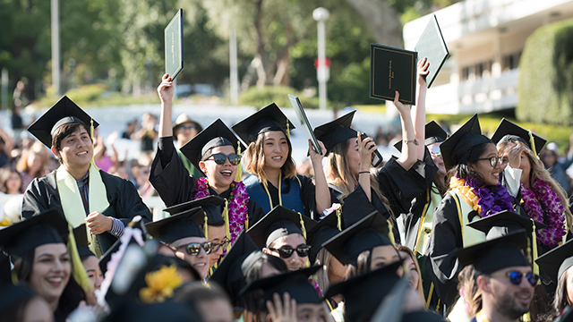 graduates celebrating during Commencement