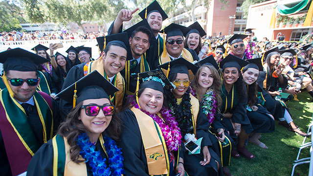 Group of grads smile during the 2018 College of Science Commencement Ceremony.