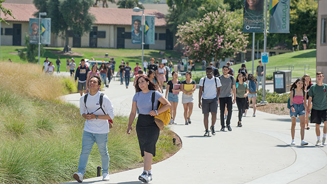 students walk across campus
