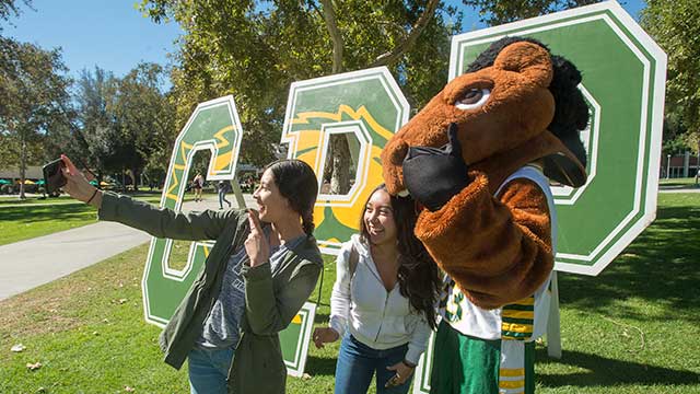Female students take a selfie with classic Billy Bronco.