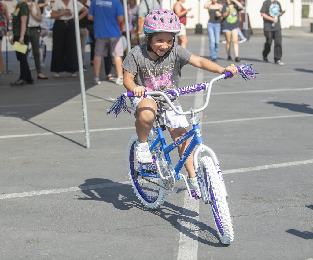 Bike Giveaway Hidalgo Bike Giveaway Hidalgo-Destiny Hidalgo, age 7, tries out her new bike that was put together by Cal Poly Pomona administrators as a team building exercise. The bikes were donated to youngsters in Pomona at the Pomona CommUnity Pull Up at Sacred Heart Church September 6, 2022.