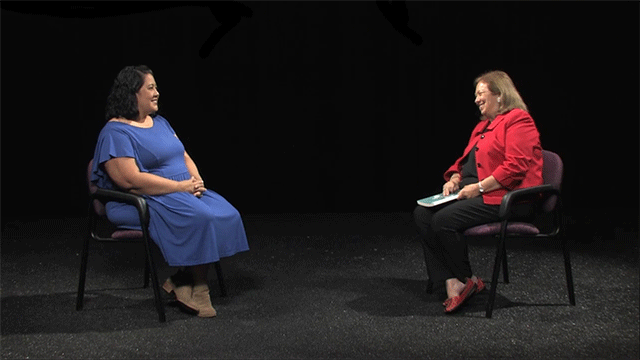 Two women seated across each other talking during the "Equity Minded Leadership" podcast.