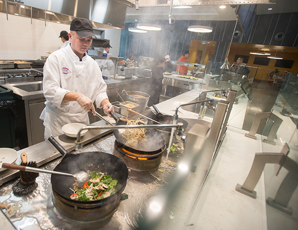 Chef cooking at the Mongolian Grill section. 