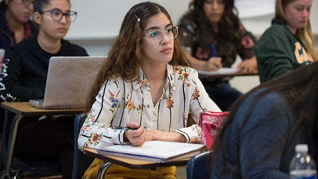 Female student listens to a lecture.