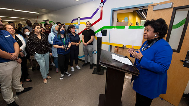 President Coley speak to faculty and staff during the iLab reopening.