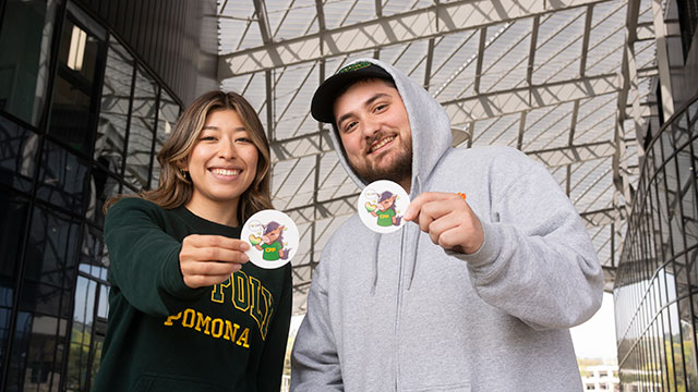 Christopher Castaneda and Ari Muramoto with Giving Day stickers.