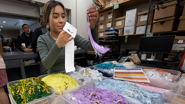 Tassles are distributed at Grad Fair at the Bronco Bookstore.