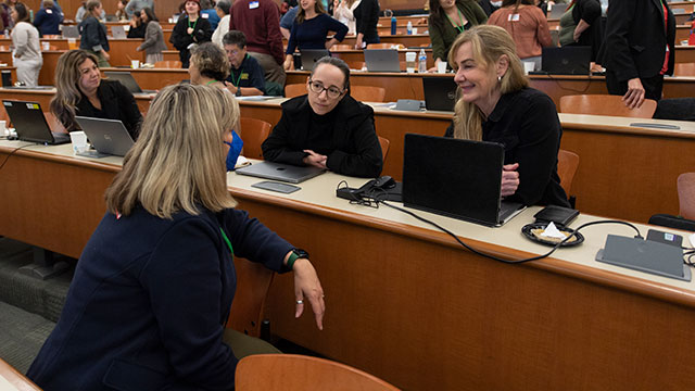 People talking to each other during the summer conference.