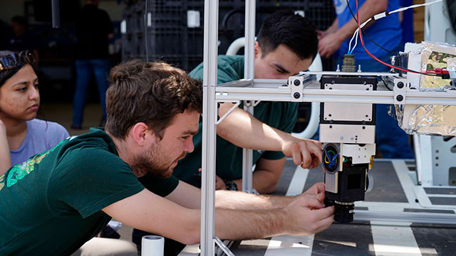 Zachary Gaines ('23, aerospace engineering), who now serves as a Bronco Space research associate, works on the Bronco Ember CubeSat.