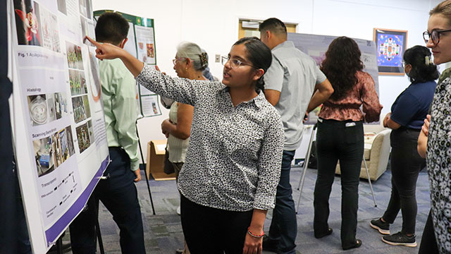 A student shares her research during a presentation.