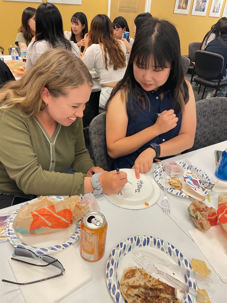 Two students work on a project together. 
