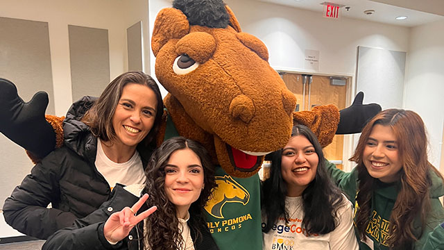 Billy Bronco with a group of female students.