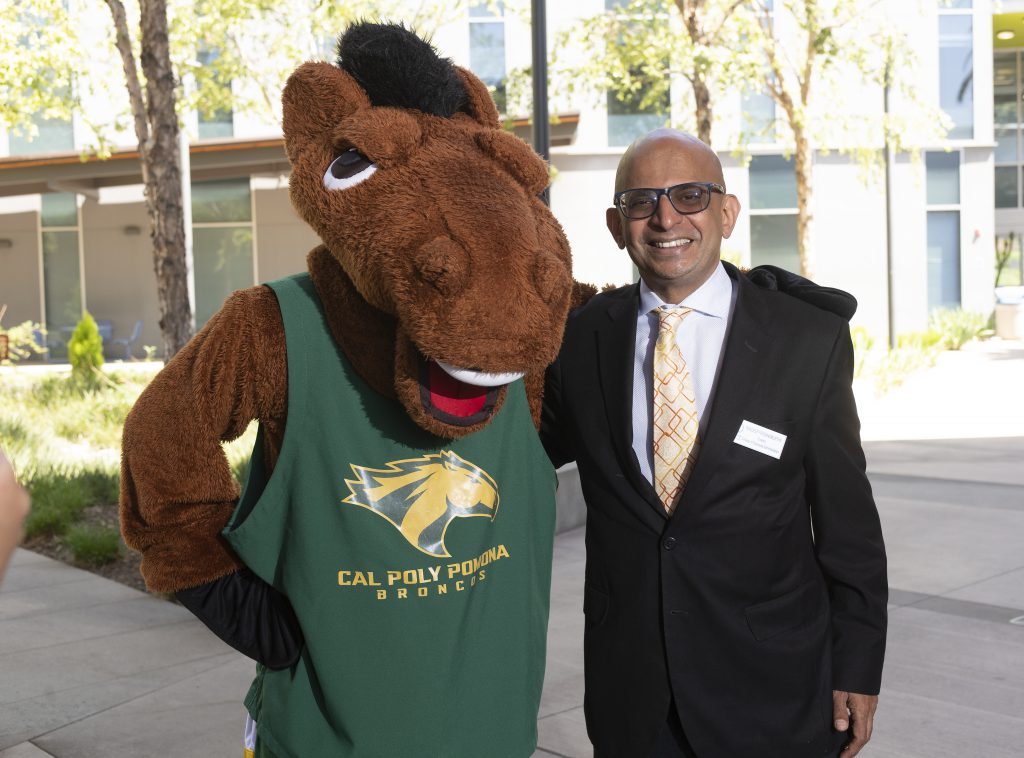 Dean Sandeep Krishnamurthy with Billy Bronco at the College of Business Administration.