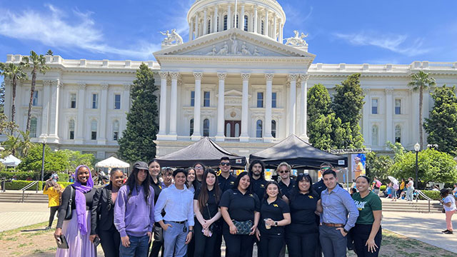 Students pose for a photo in front of the capitol building