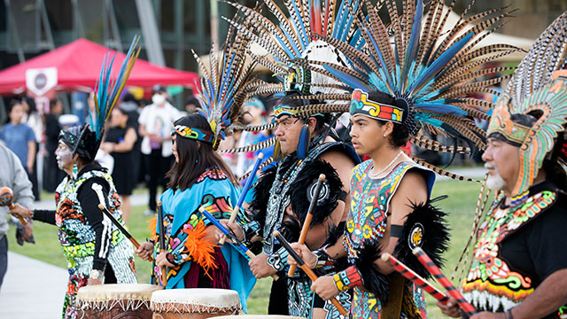 Aztec Dancers and musicians play drums during the 2022 Dia De Los Muertos Celebration
