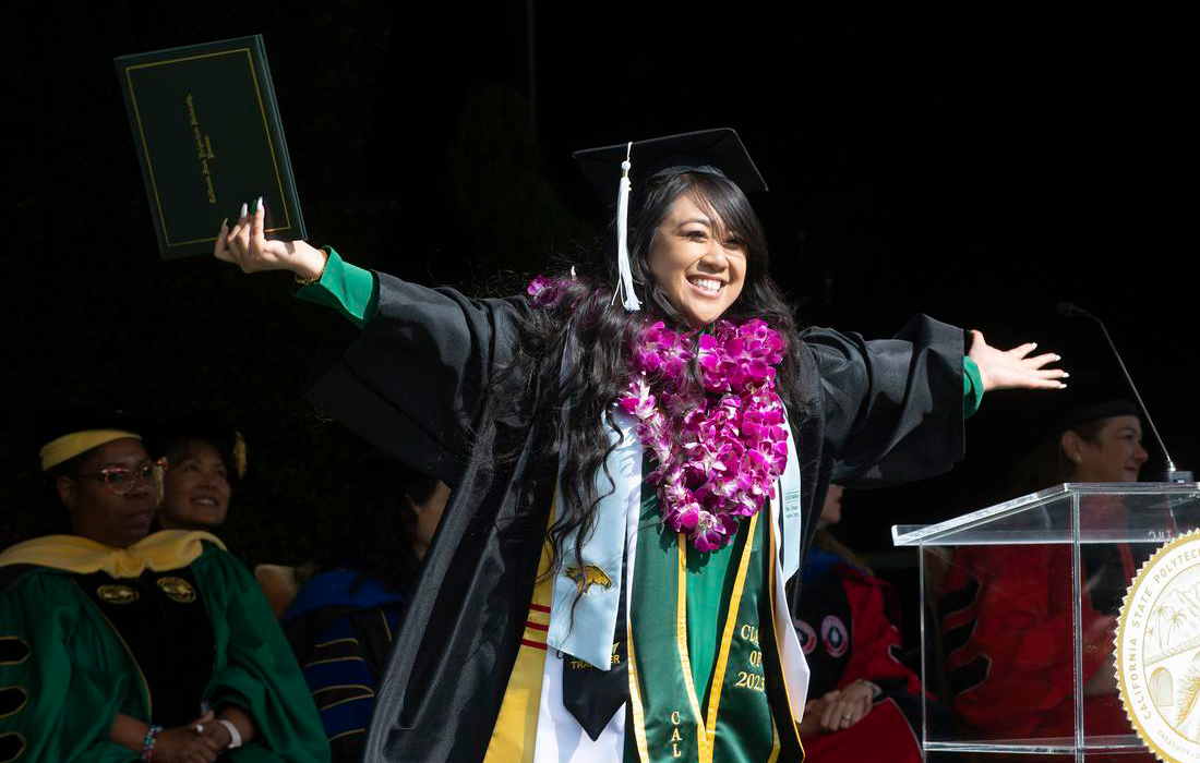 A graduate celebrating during Commencement