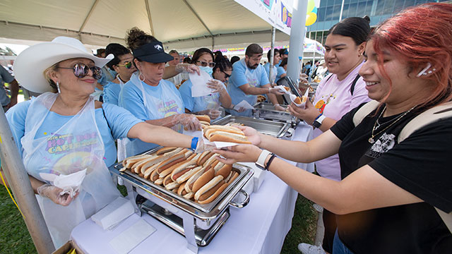 Volunteers hand out hot dogs during the 2022 Hot Dog Caper.