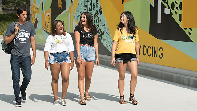 Student walking along the mural at parking structure II.