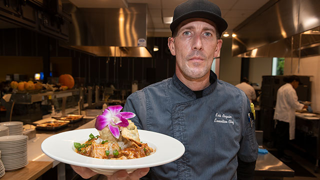 Chef Kris Arguin with a vegan mapo tofu at the Halal station at Centerpointe Dining Commons.