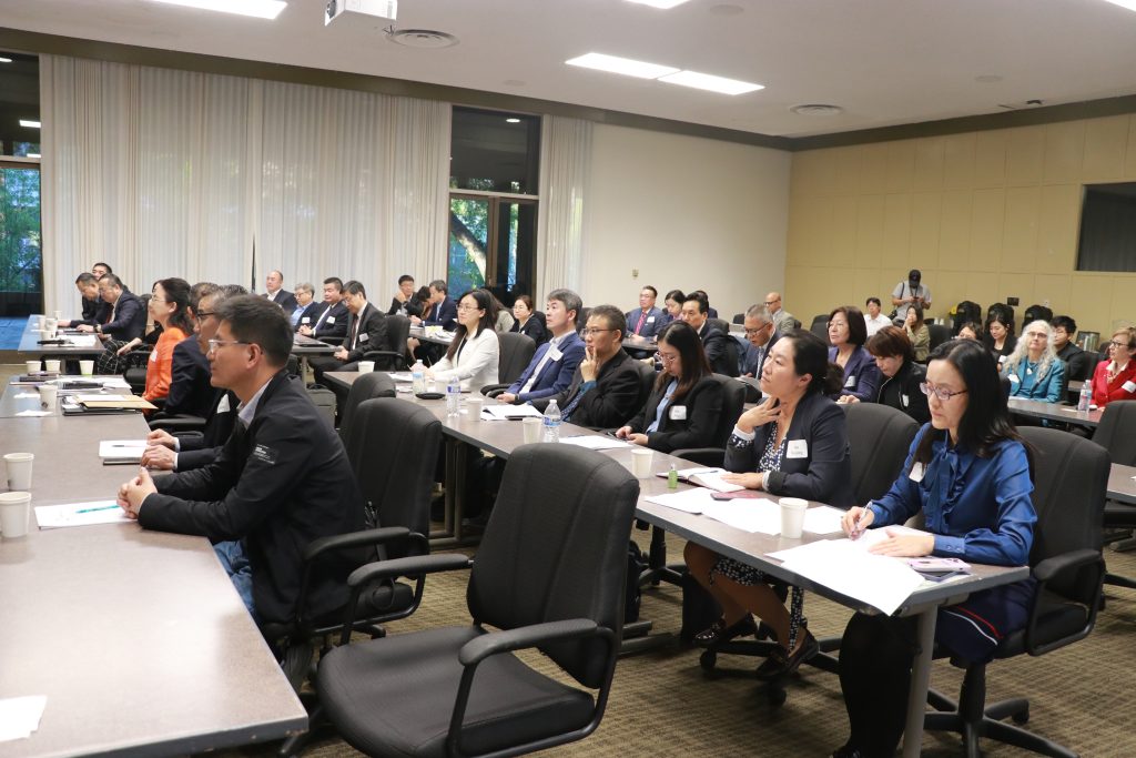 A group of people listen in on the panel discussion.