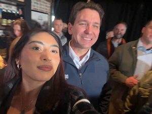 Female student takes a selfie with Ron Desantis.