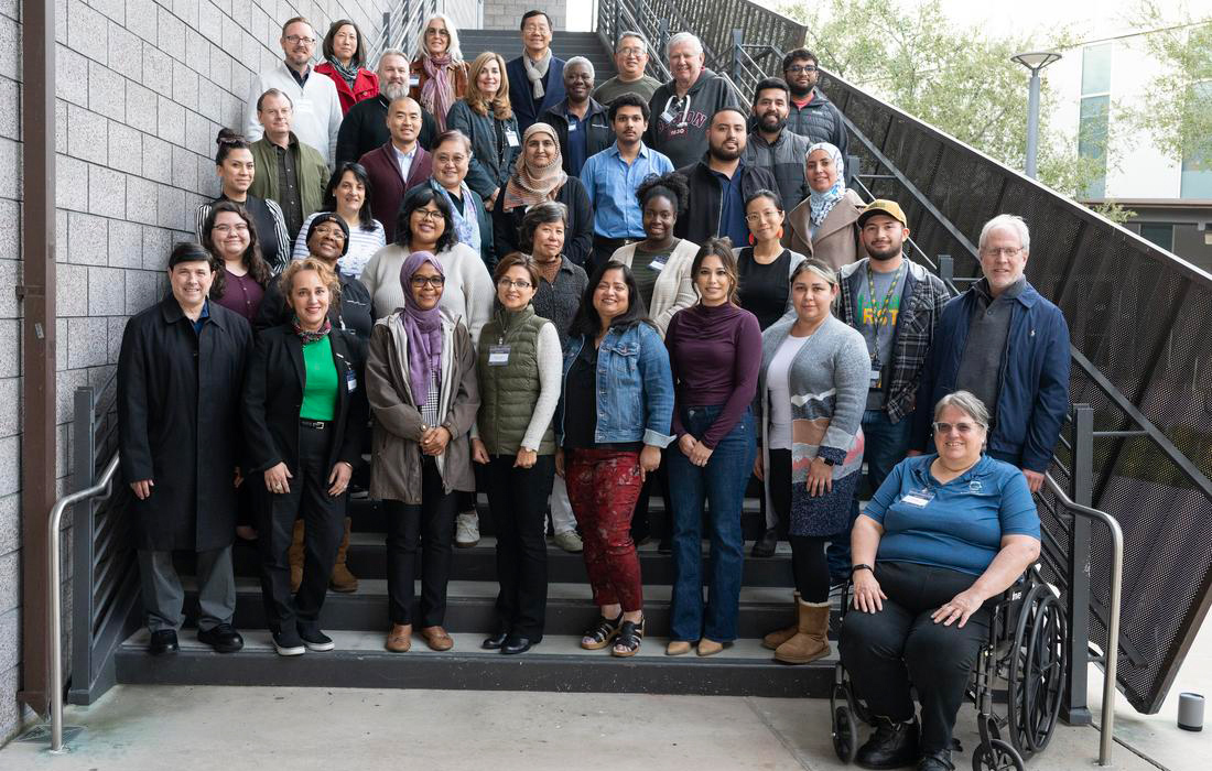 The 2024 Winter Institute cohort pose for a group photo on a staircaise.