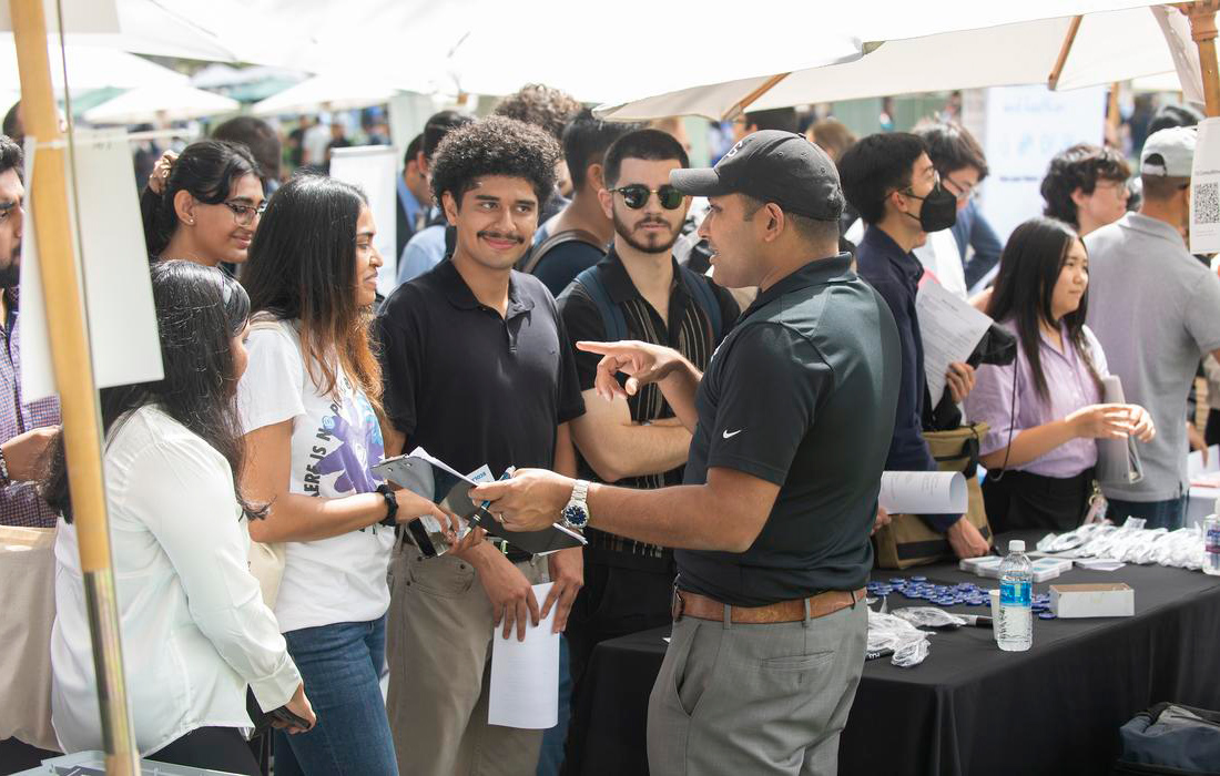 Students talk to a recruiter during the Fall STEM Career Fair.