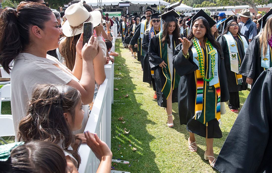 A family member take a picture of a graduate