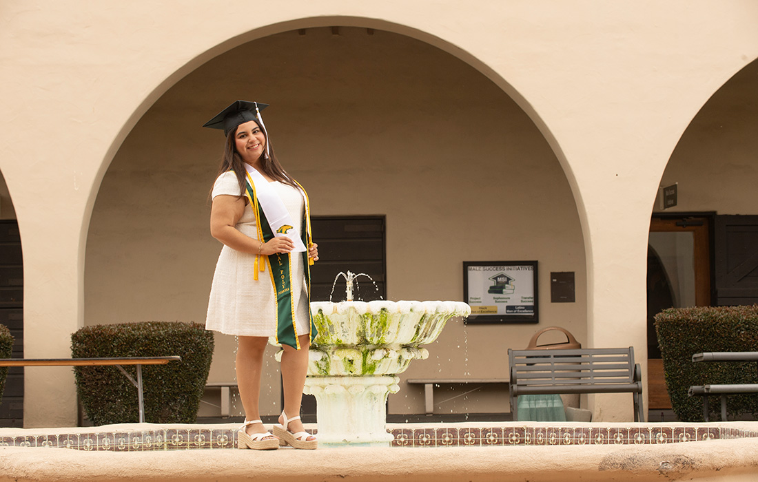 Anais Hernandez smiles while standing at the old stables. 