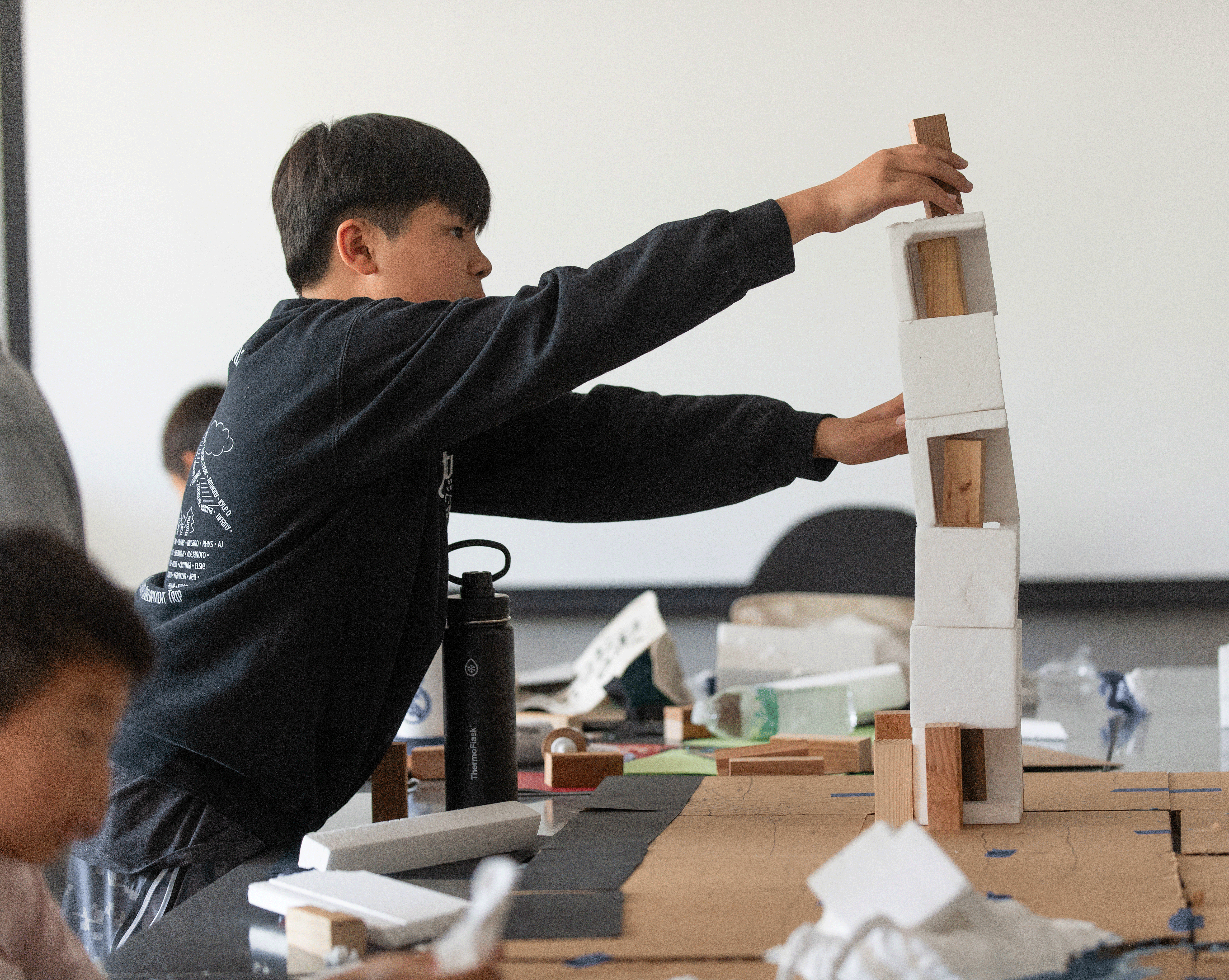 Mason Siah makes a tower for a city during ENV Camp