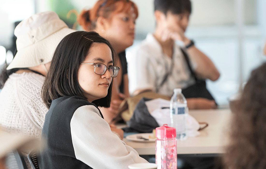 Asian American student listens during PolyTransfer orientation.