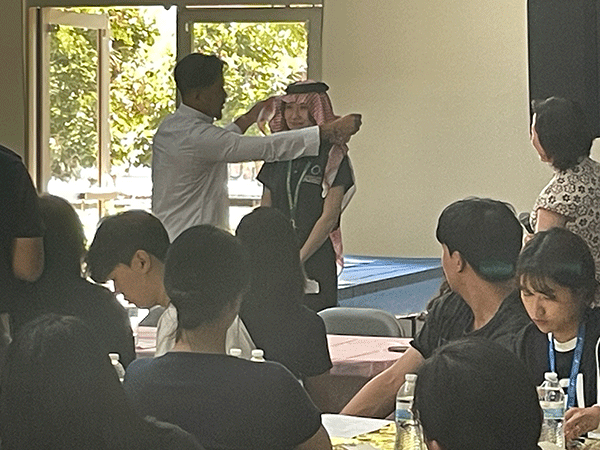 student presented with cultural exchange headdress