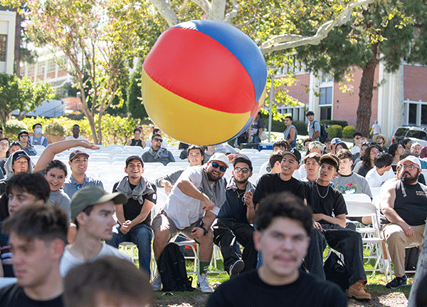 Engineering students play with a beach ball during New Student Convocation.